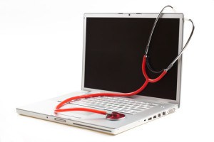 silver laptop diagnosis with red stethoscope isolated on white background